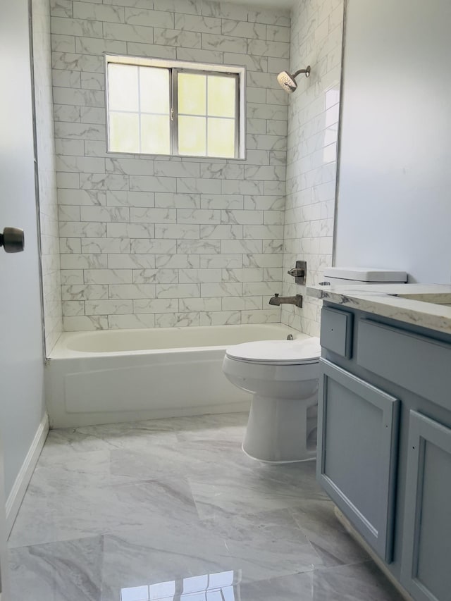 full bathroom with vanity, toilet, and tiled shower / bath