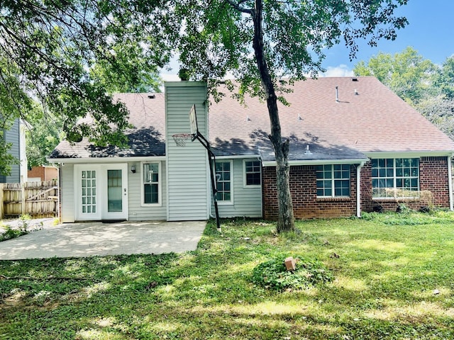 back of house with a yard and a patio