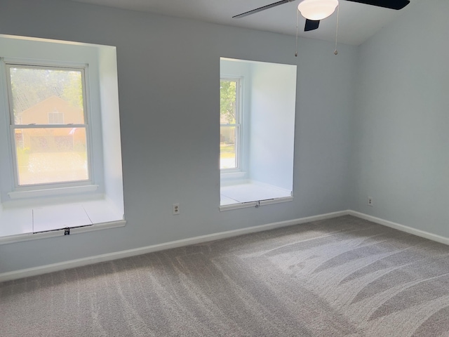 carpeted spare room featuring ceiling fan