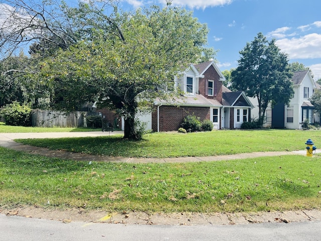 view of front of house featuring a front lawn and a garage