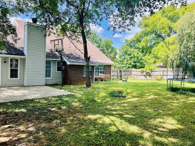 view of yard featuring a patio area and a trampoline