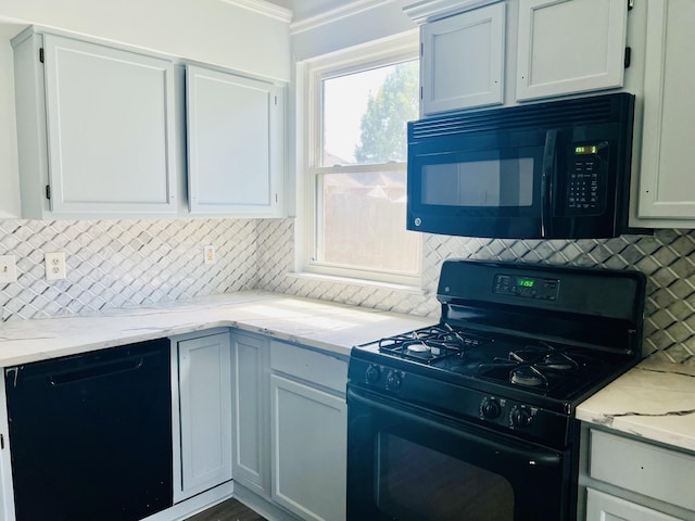 kitchen with black appliances, white cabinets, and tasteful backsplash