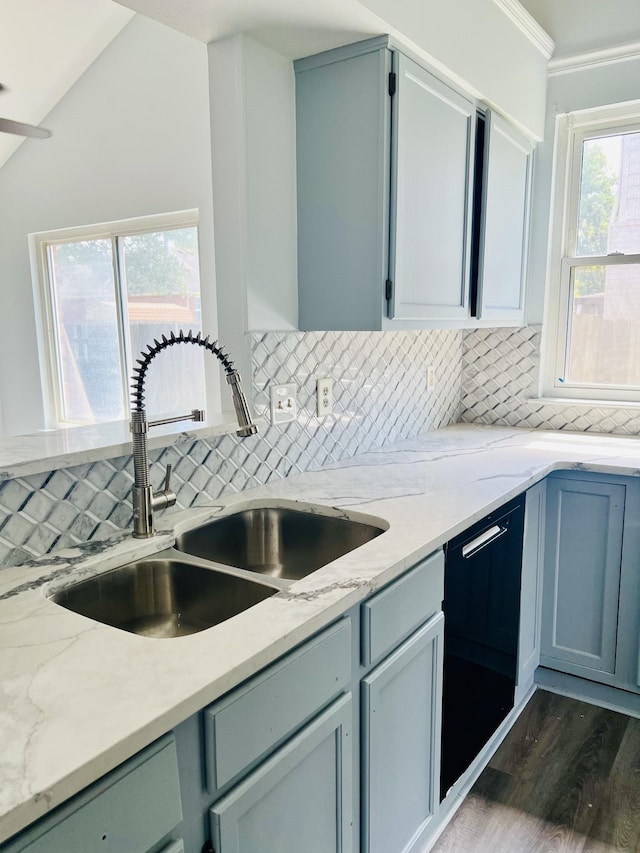 kitchen with a wealth of natural light, dishwasher, sink, and decorative backsplash