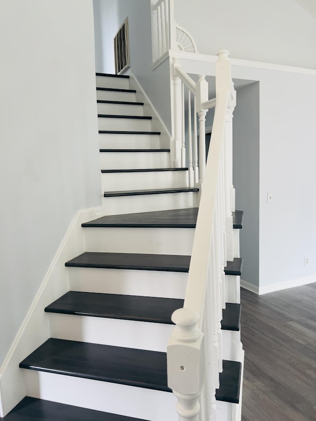 staircase featuring wood-type flooring