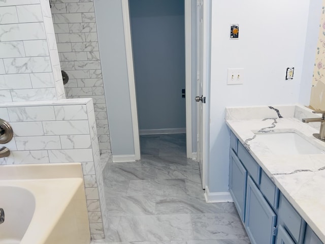 bathroom featuring a tub to relax in and vanity