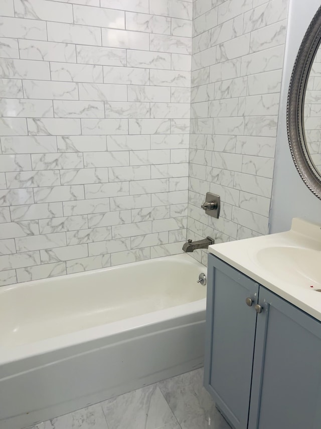 bathroom featuring vanity and tiled shower / bath combo