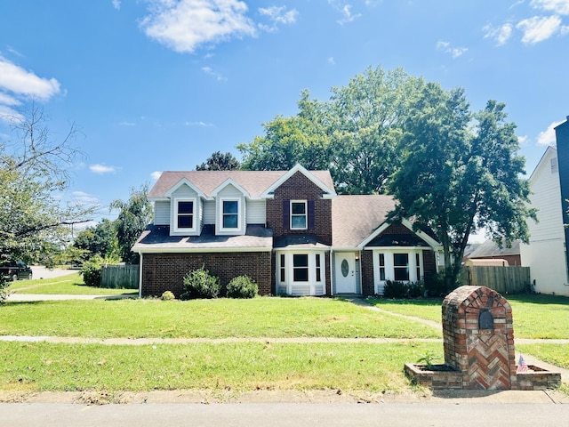 new england style home featuring a front lawn