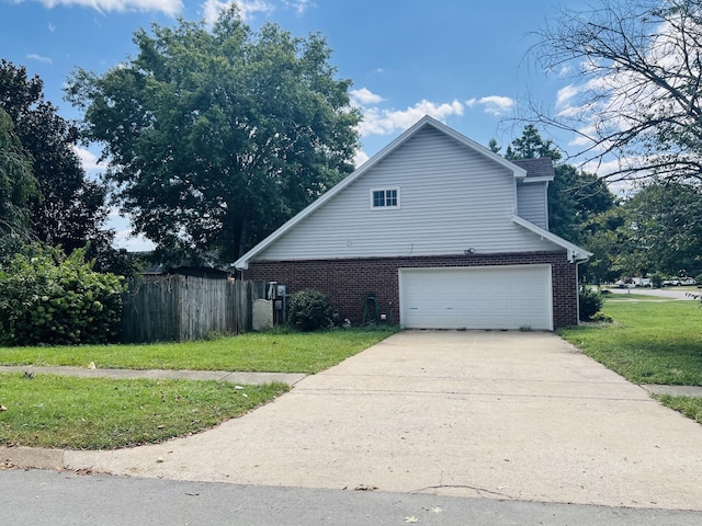 view of side of property with a lawn and a garage