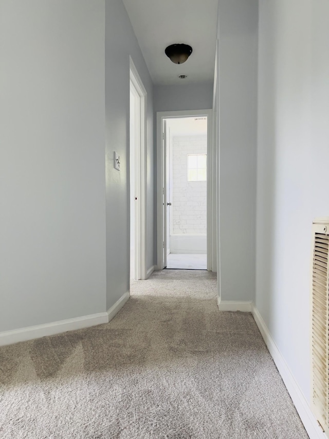 hall with light colored carpet