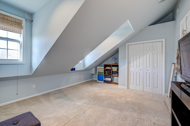 additional living space featuring carpet and lofted ceiling