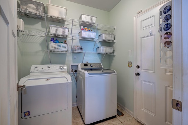 laundry area featuring washer and clothes dryer and light tile patterned floors