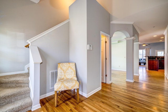 sitting room with decorative columns, light hardwood / wood-style flooring, and ornamental molding