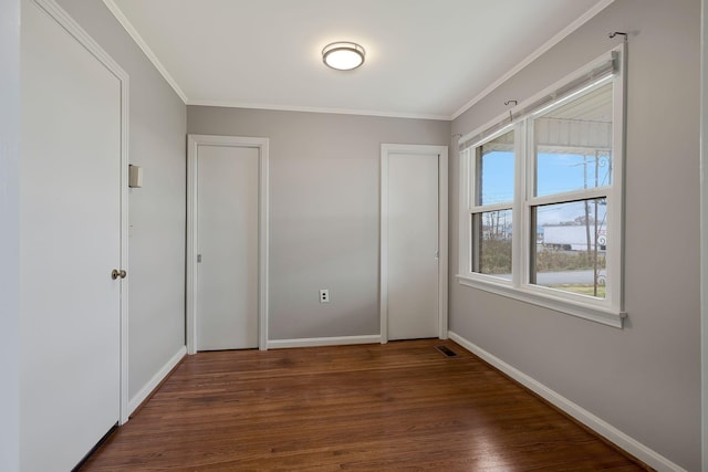 interior space with dark hardwood / wood-style floors and ornamental molding