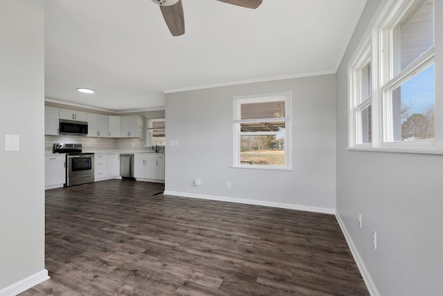 unfurnished living room featuring ceiling fan, sink, dark hardwood / wood-style floors, and ornamental molding