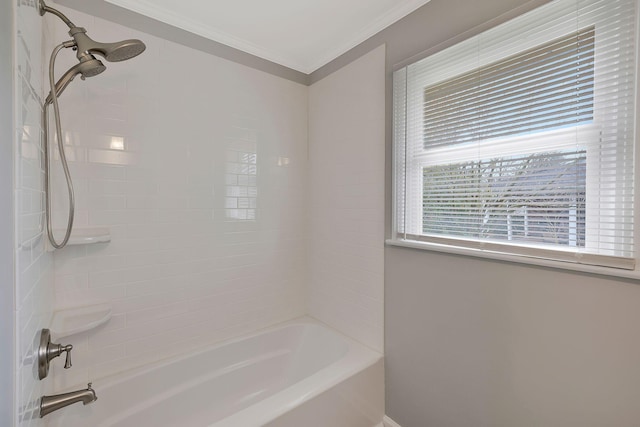 bathroom with tiled shower / bath combo and crown molding