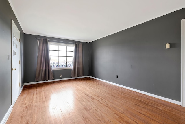 spare room with light hardwood / wood-style flooring and ornamental molding