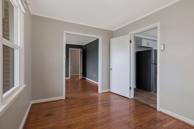 unfurnished room with hardwood / wood-style flooring and ornamental molding