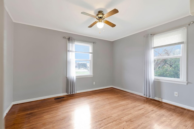 empty room with light wood-type flooring, a wealth of natural light, and ceiling fan