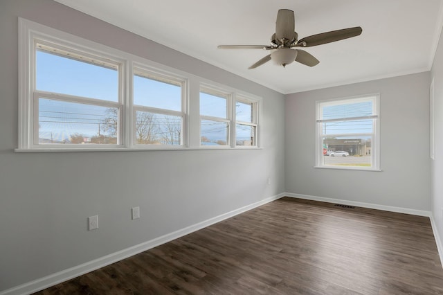 empty room featuring ceiling fan, dark hardwood / wood-style flooring, and ornamental molding