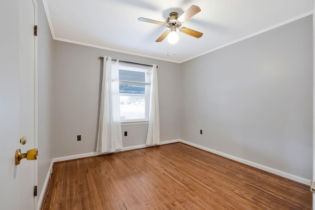 empty room with crown molding, ceiling fan, and hardwood / wood-style flooring