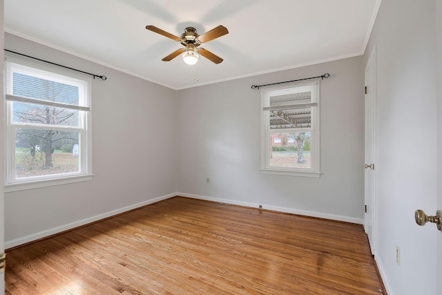 empty room with ceiling fan, a healthy amount of sunlight, and light hardwood / wood-style flooring