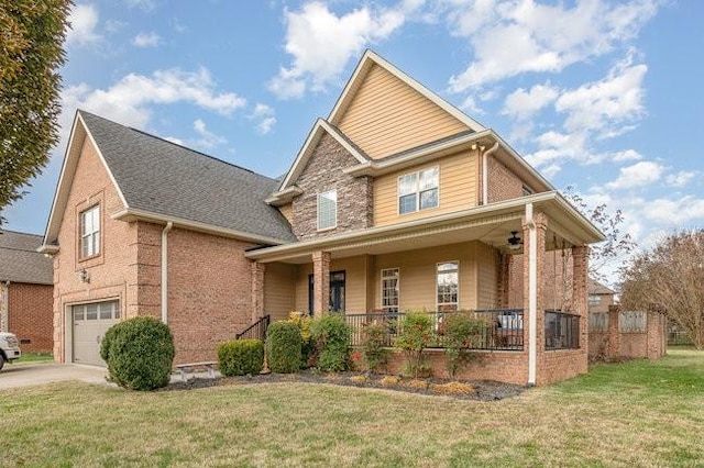 view of front of home with a front lawn, a porch, and a garage