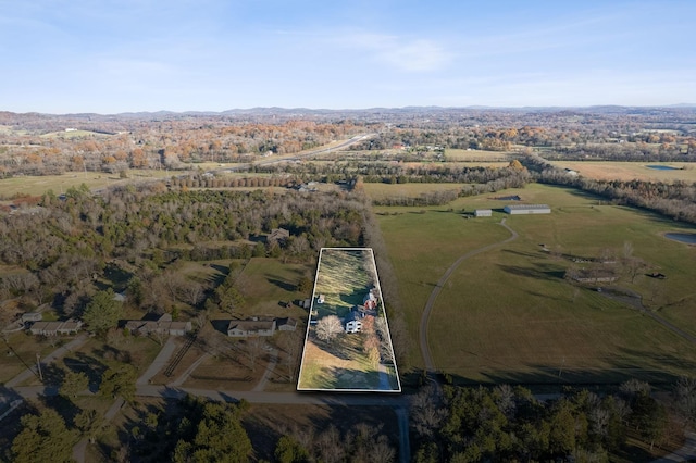 birds eye view of property with a rural view