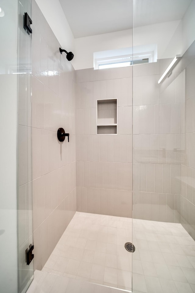 bathroom with a tile shower