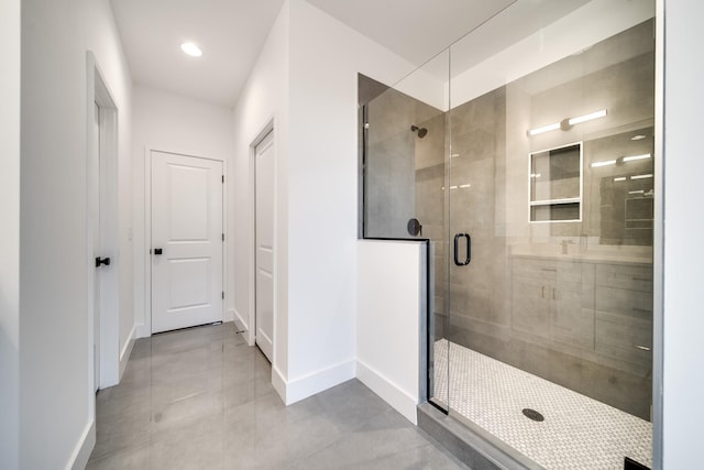 bathroom featuring tile patterned floors and a shower with door