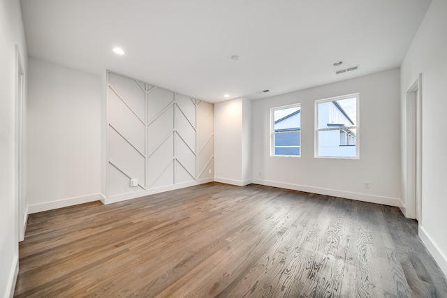 unfurnished room featuring hardwood / wood-style flooring