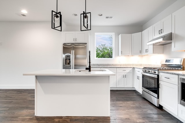 kitchen featuring appliances with stainless steel finishes, white cabinetry, and an island with sink