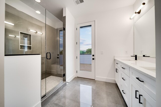 bathroom with vanity, an enclosed shower, and concrete flooring