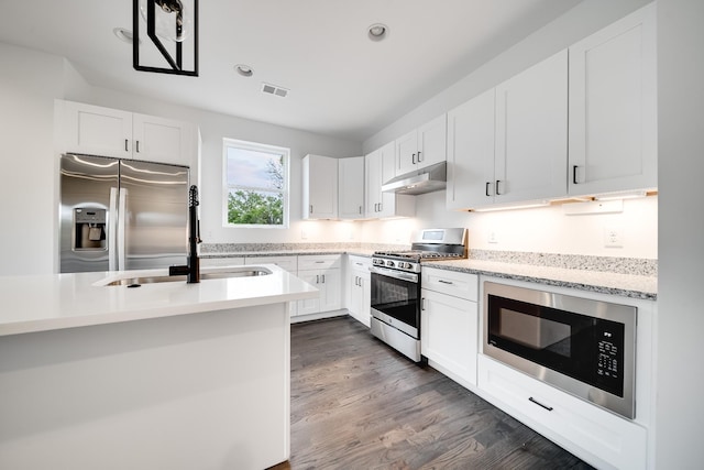 kitchen featuring dark hardwood / wood-style floors, white cabinetry, sink, and appliances with stainless steel finishes