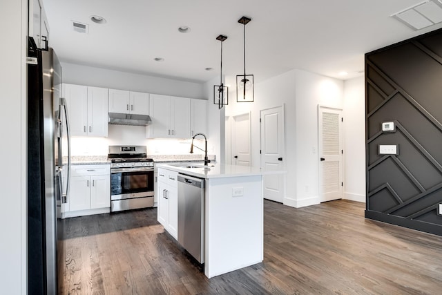 kitchen with dark wood-type flooring, white cabinets, sink, an island with sink, and appliances with stainless steel finishes