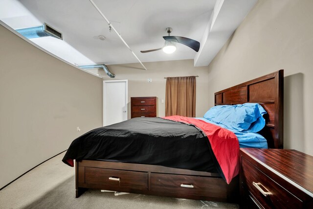 carpeted bedroom featuring rail lighting and ceiling fan