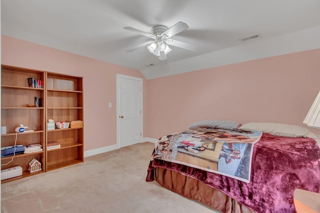 carpeted bedroom with vaulted ceiling and ceiling fan