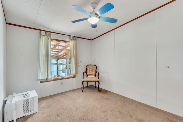 sitting room featuring light carpet, a textured ceiling, ceiling fan, and crown molding