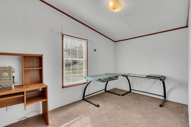 office space with a textured ceiling, light colored carpet, lofted ceiling, and crown molding