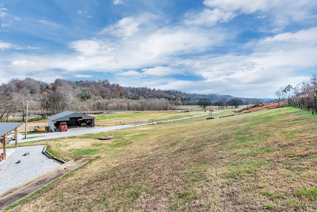 view of yard featuring a rural view and a carport