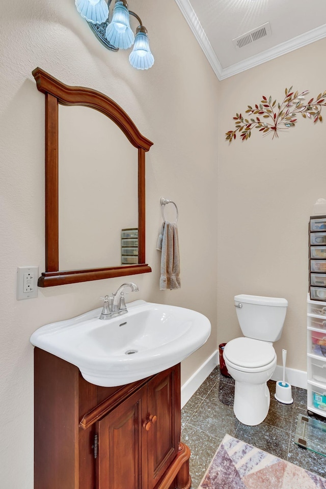 bathroom featuring vanity, toilet, and crown molding