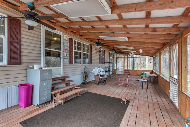 sunroom / solarium with lofted ceiling with beams and ceiling fan