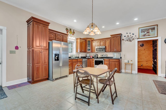 kitchen with decorative light fixtures, ornamental molding, appliances with stainless steel finishes, and an inviting chandelier