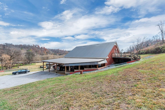 exterior space with a carport and a yard