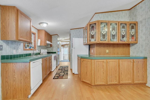 kitchen with a textured ceiling, white appliances, vaulted ceiling, crown molding, and light hardwood / wood-style flooring