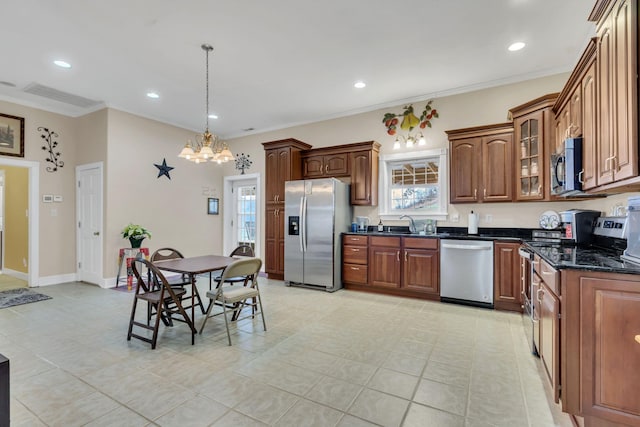 kitchen with pendant lighting, light tile patterned floors, ornamental molding, appliances with stainless steel finishes, and a chandelier