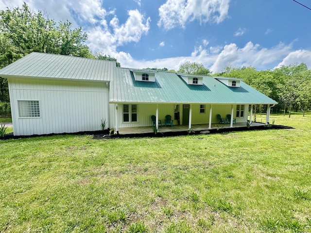 rear view of property featuring a yard