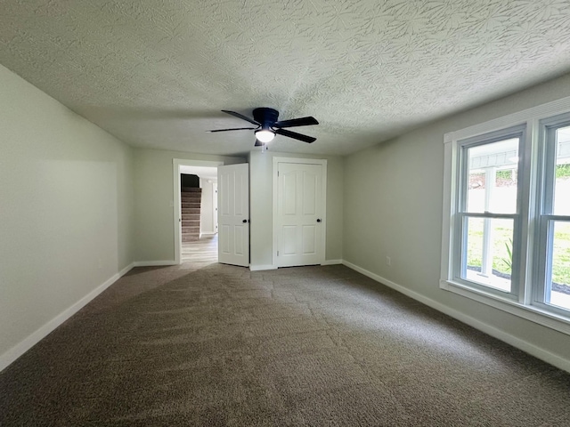 interior space featuring ceiling fan and a textured ceiling