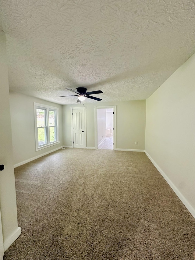 carpeted empty room with a textured ceiling and ceiling fan