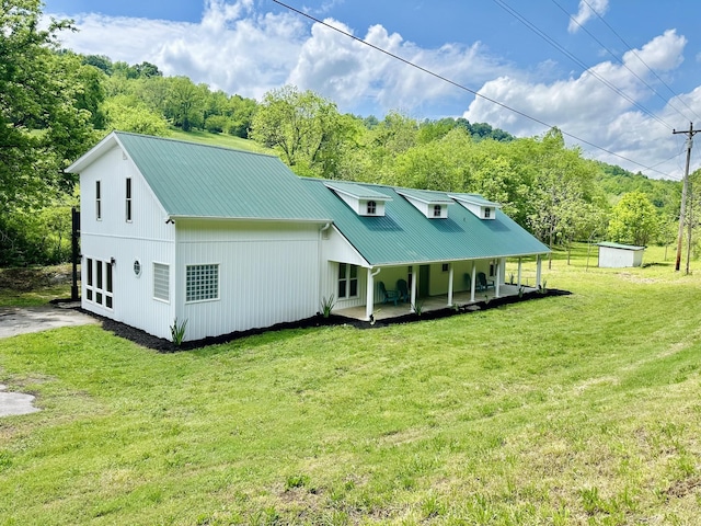 rear view of house featuring a patio area and a lawn