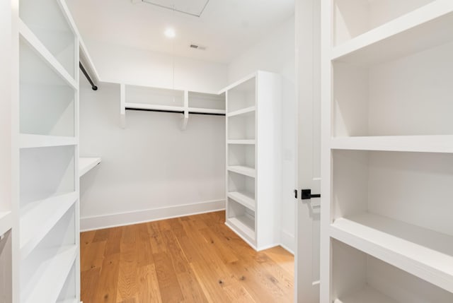 spacious closet featuring light hardwood / wood-style floors